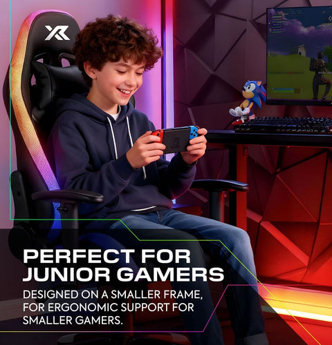 Child playing video games in a gaming chair with ergonomic design, surrounded by gaming equipment.