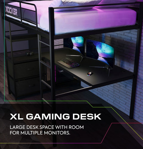 Gaming desk with computer setup under a loft bed in a room with brick walls.
