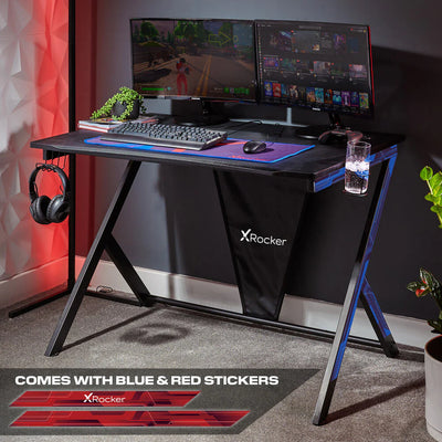 X Rocker gaming desk featuring monitors, a keyboard, headphone hook and cup holder